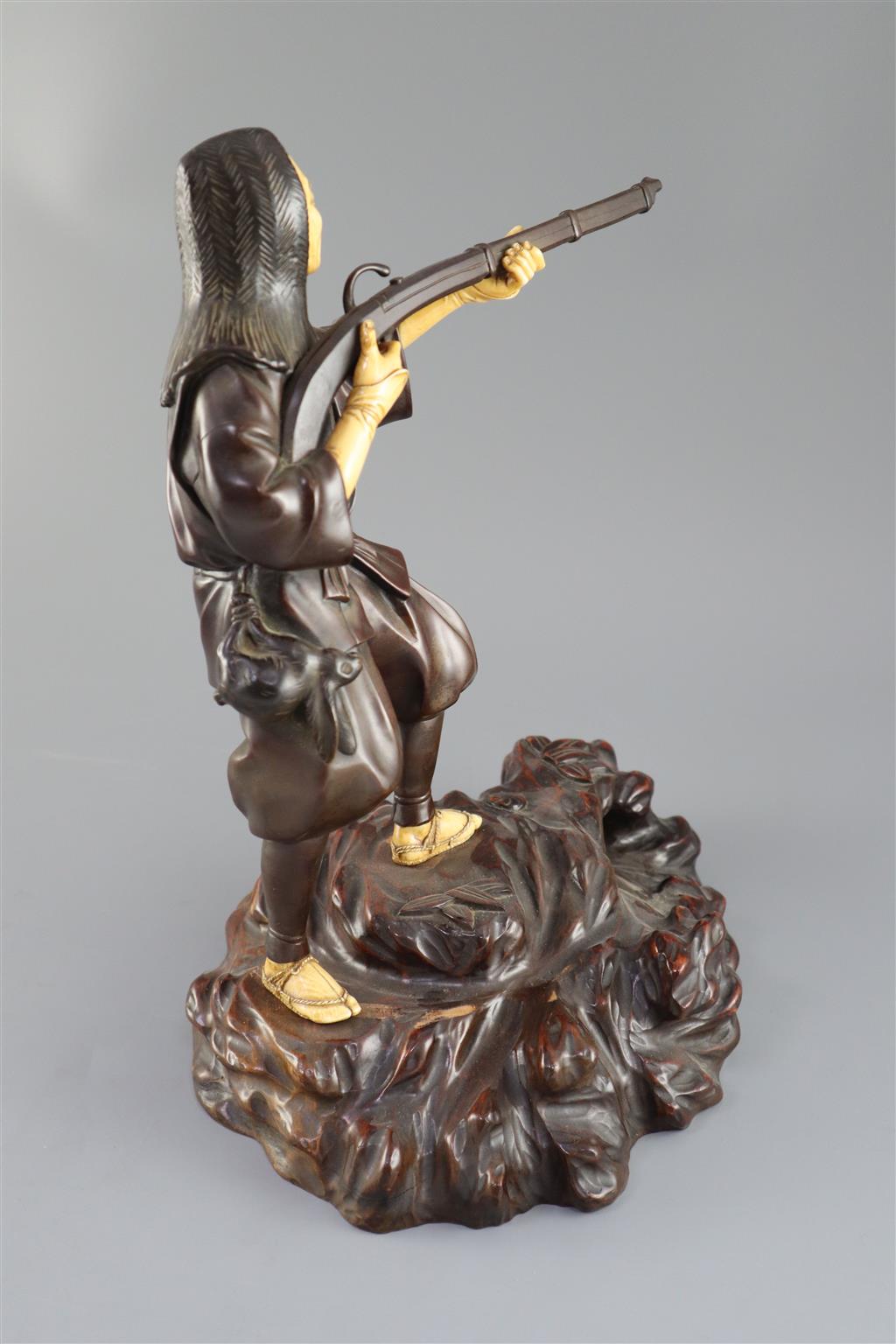 A good Japanese bronze and ivory okimono of a huntsman, Meiji period, 34cm high